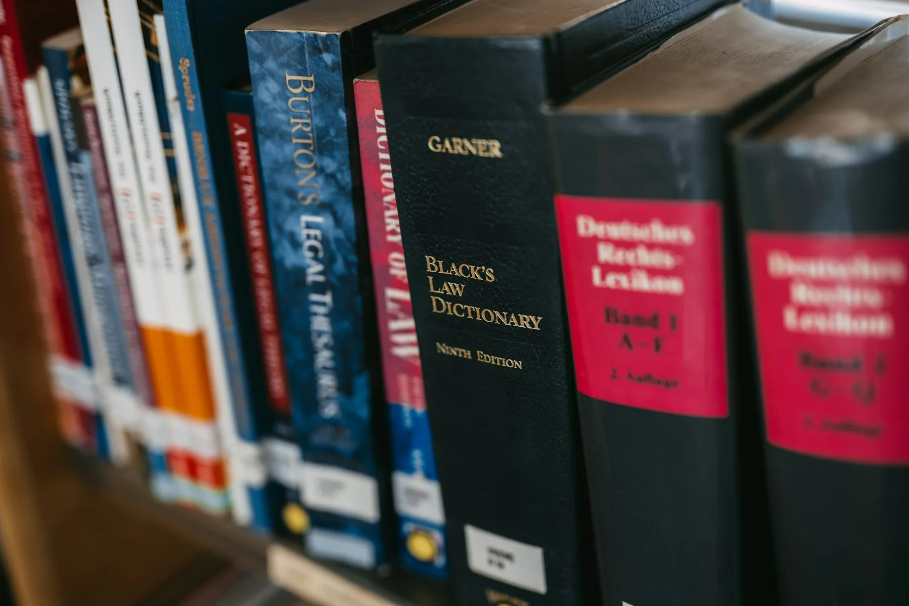 Law reference books on a shelf, with a legal dictionary in the centre